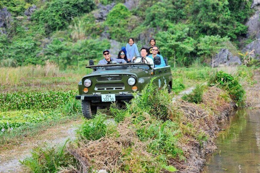 Ninh Binh Jeep Adventure: Explorers embark on an exhilarating off-road expedition, riding through the stunning landscapes of Ninh Binh in a jeep, capturing unforgettable moments along the way