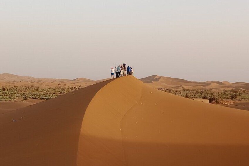 enjoy sunset from up the dunes of Erg Chigaga Desert is a most try experience