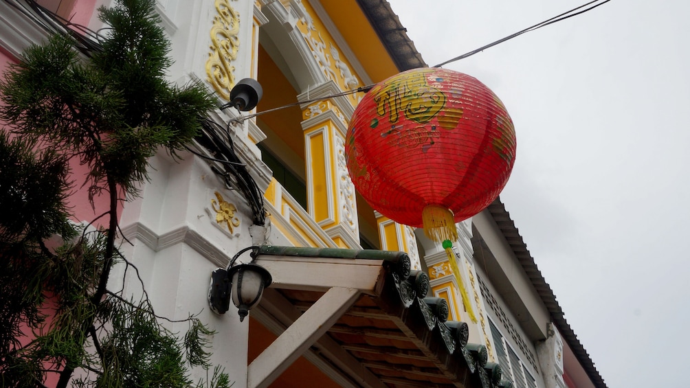 Show item 3 of 4. Paper lantern hanging from a building in Phuket