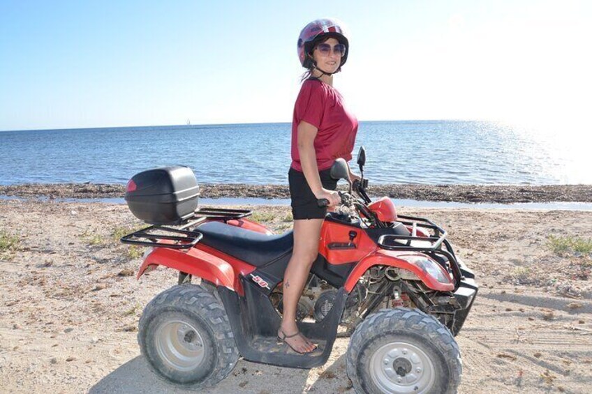 Quad tour between vineyards and the sea with a glass of wine.