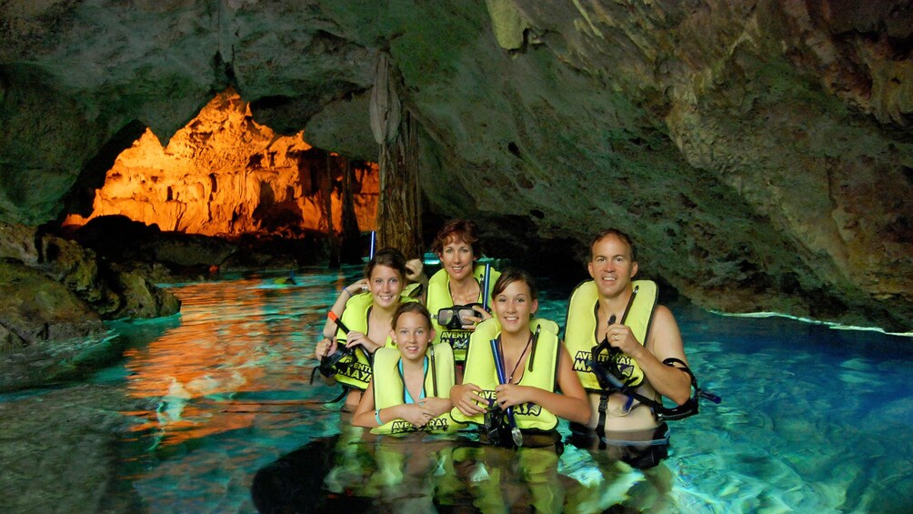 Family has picture taken while snorkeling in Cenote in Cancun