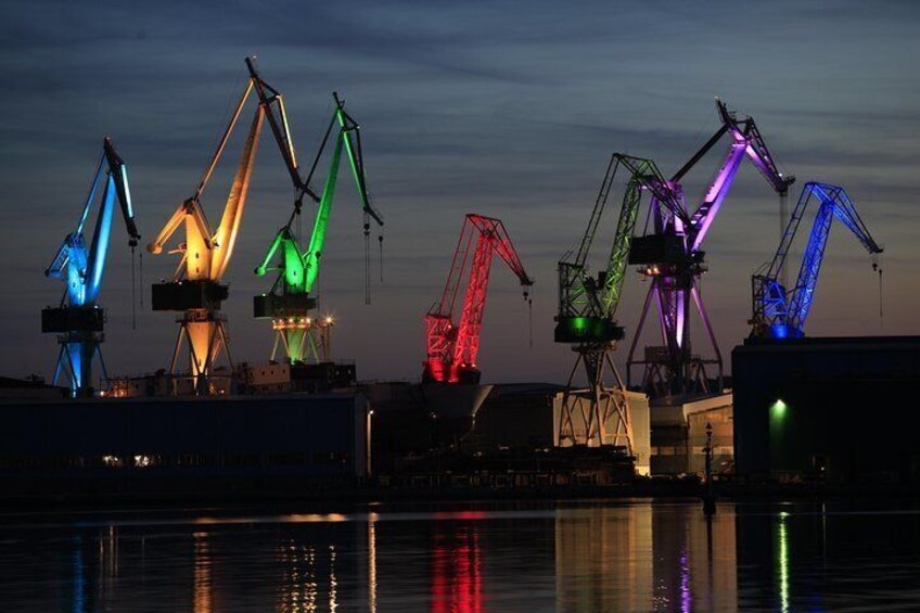 The illuminated cranes of the Scoglio olivi shipyard