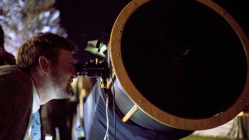 Man looking at the stars  through large telescope in Jackson Hole