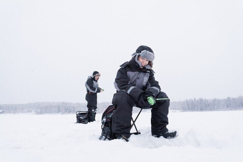 Ice Fishing on a Frozen Lake in Levi