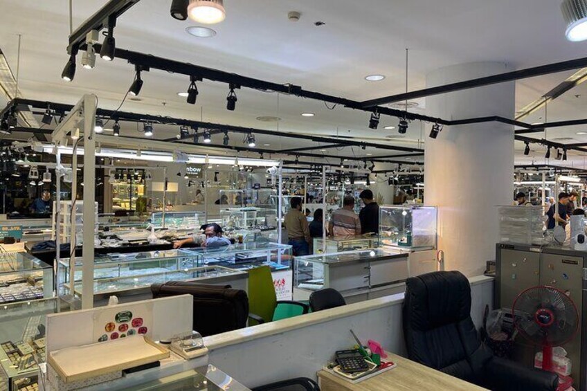 A photo of the numerous stores in the basement of Jewelry Trade Center that we will visit. As a graduate gemologist from GIA, I will also help you to select gemstones if you decide to look for one.