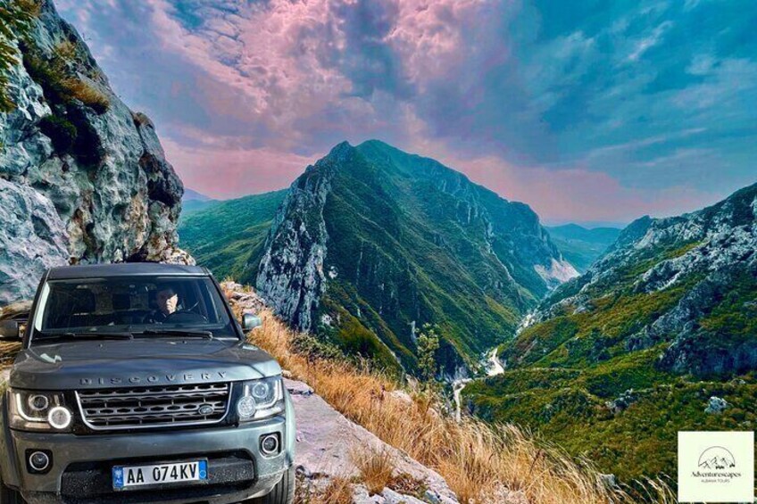 Land Rover with Bovilla Lake & Mountain in the background