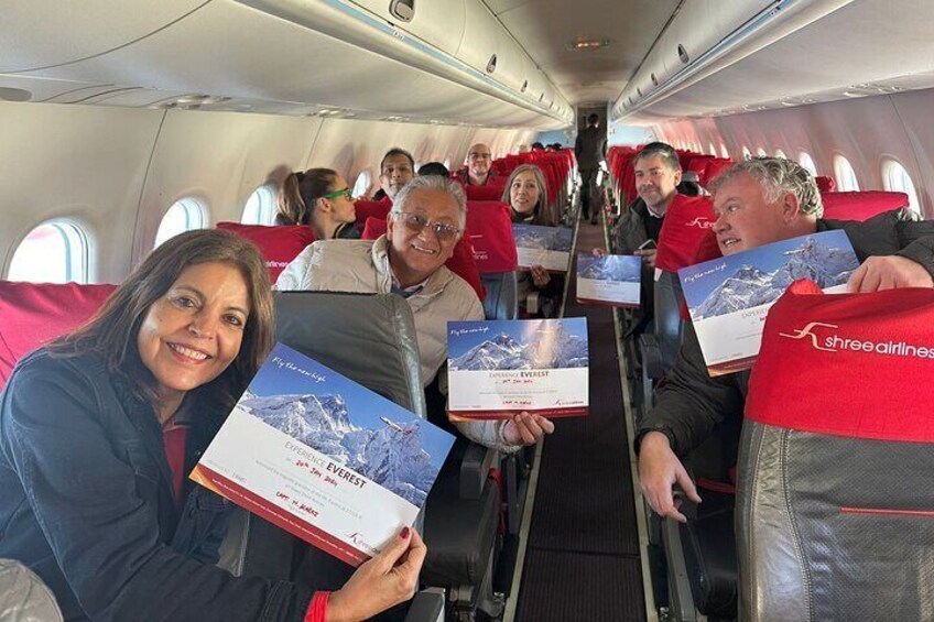 Travelers with their Adventure Certificates during the flight