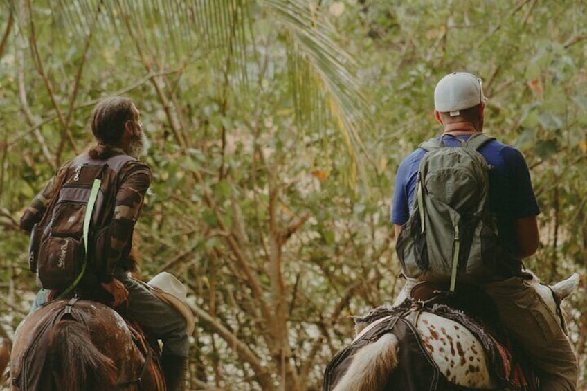 Manny and a tour goer riding through the jungle