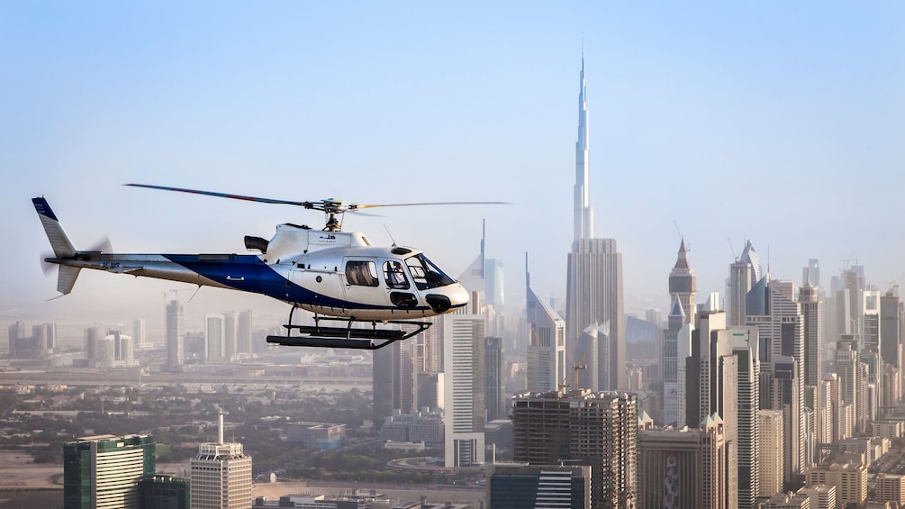 Tour helicopter flies over Dubai skyline