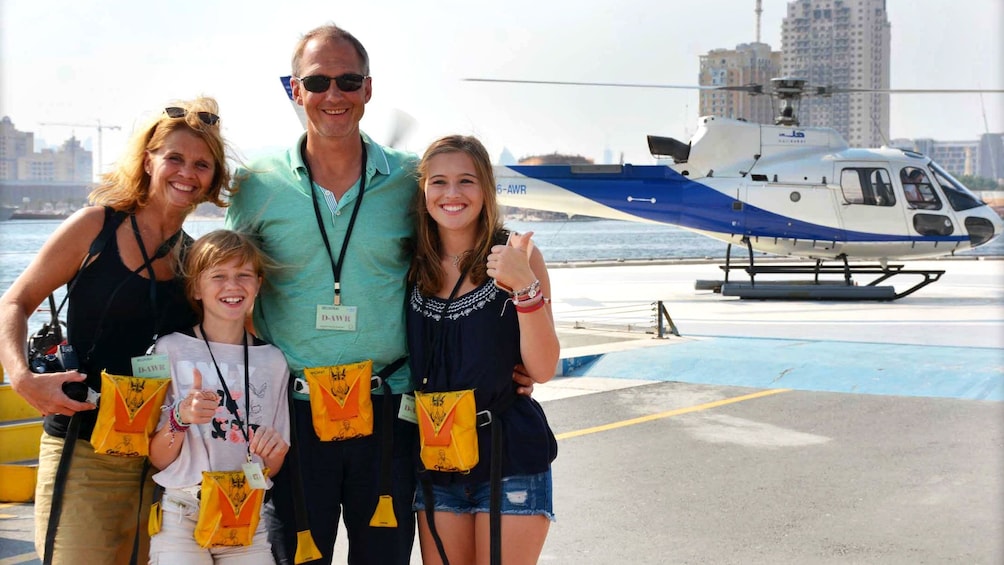 Family smiling for photo before taking helicopter tour in Dubai