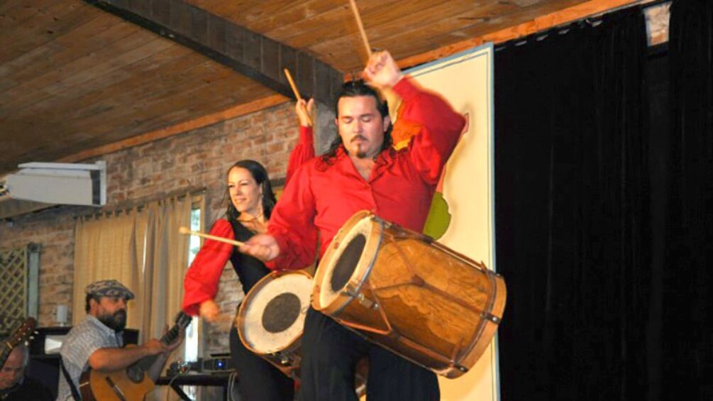 Two people playing drums