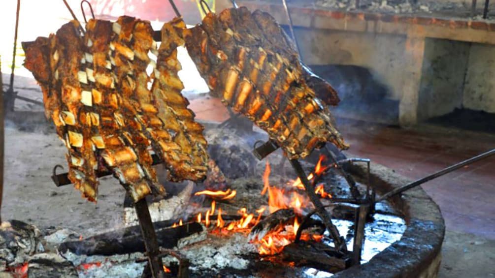 Ribs cooking over a fire pit