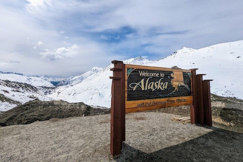 Welcome to Alaska sign at the Summit