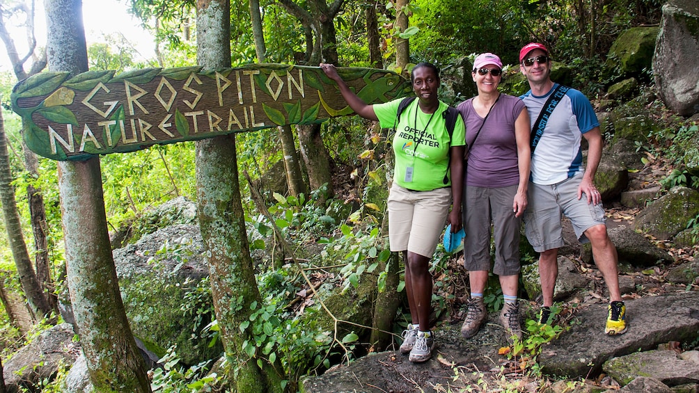 Trio poses by sign at beginning of trail of Gros Piton