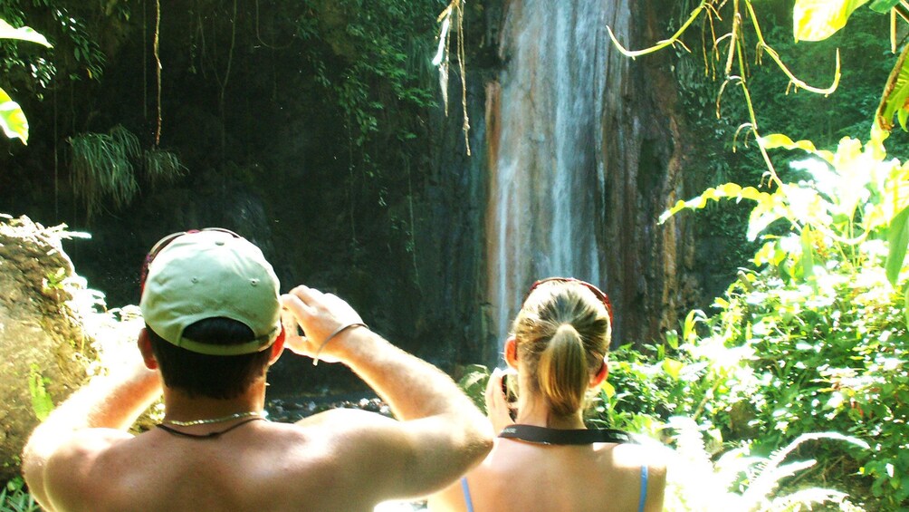 Hikers taking pictures of Diamond Falls in Soufriere