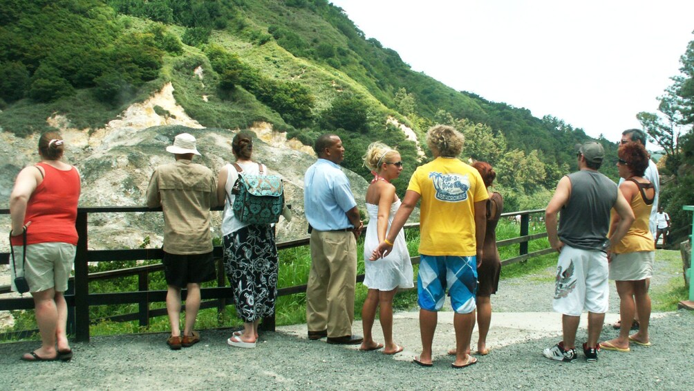 Tour group standing near volcano in Soufriere