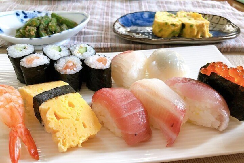 Eight hand formed sushi, a sushi roll, two side dishes and miso soup.