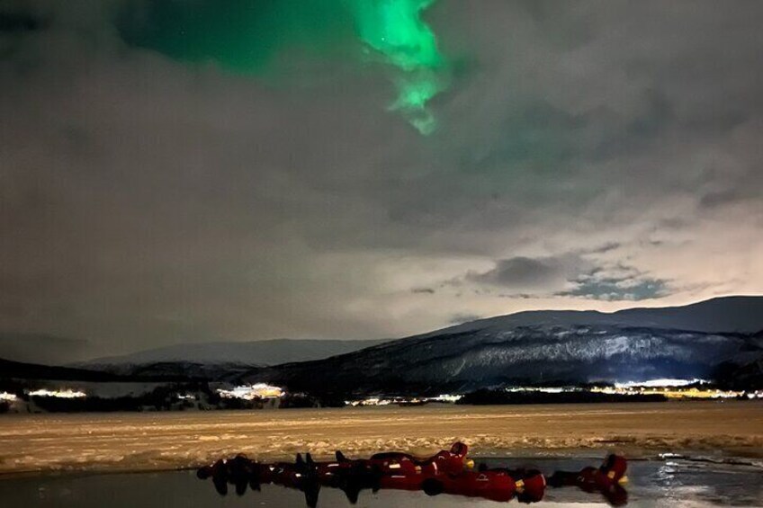Floaters in the water beneath the northern lights