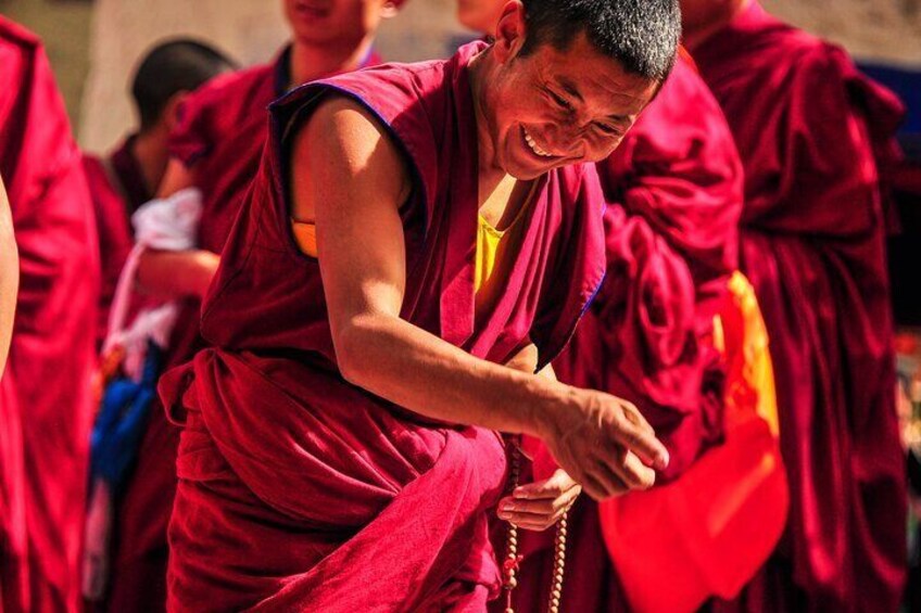 Tibetan monks engaged in a spirited debate on Buddhist scriptures.