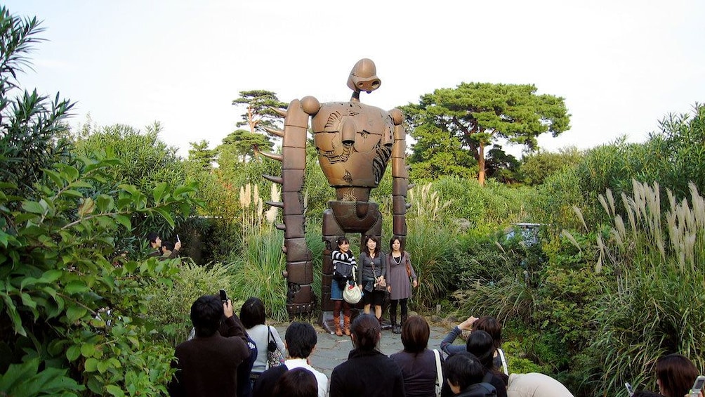 Women posts in front of statue in Studio Ghibli museum in Tokyo
