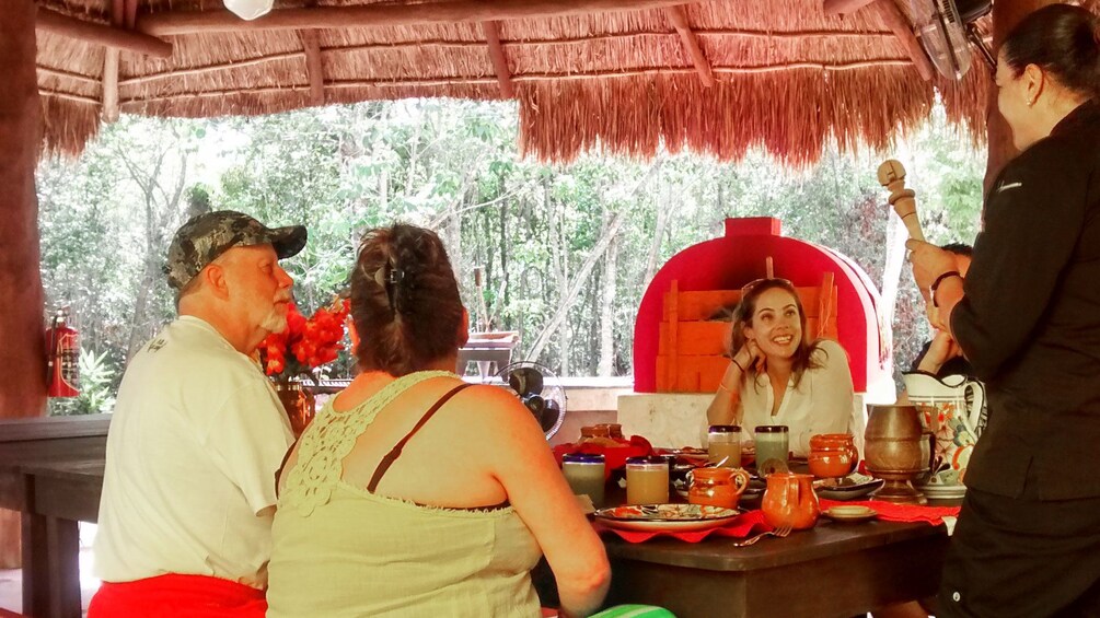 Family with chef enjoy cuisine outside in Cancun