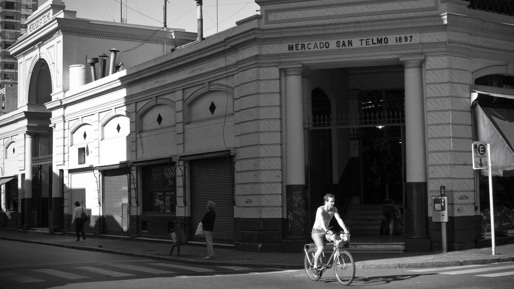 Man riding bicycle down street of Buenos Aires
