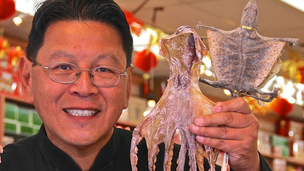 Man holding dried animals