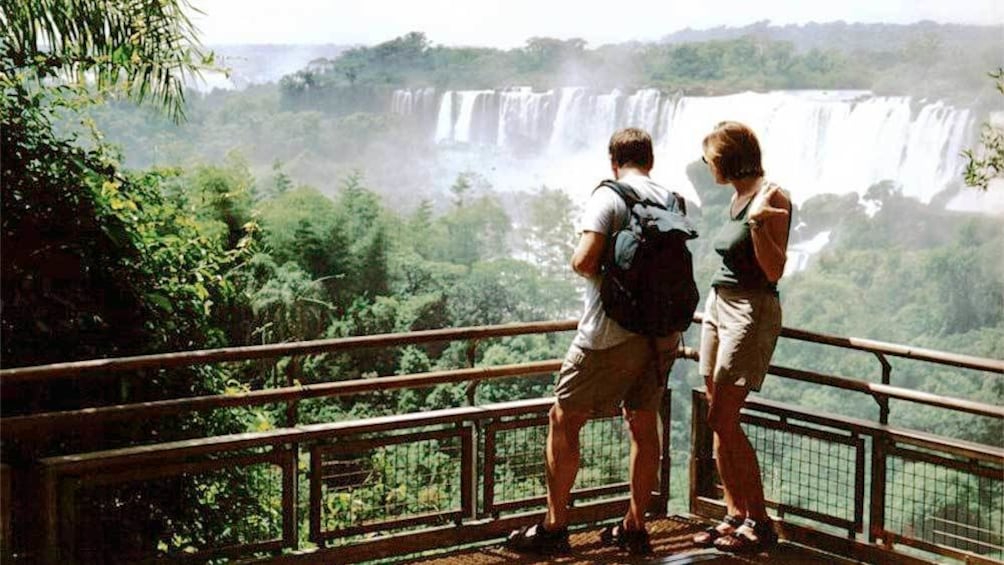 Tourists at a view point, overlooking the Iguazu Falls in Argentina 
