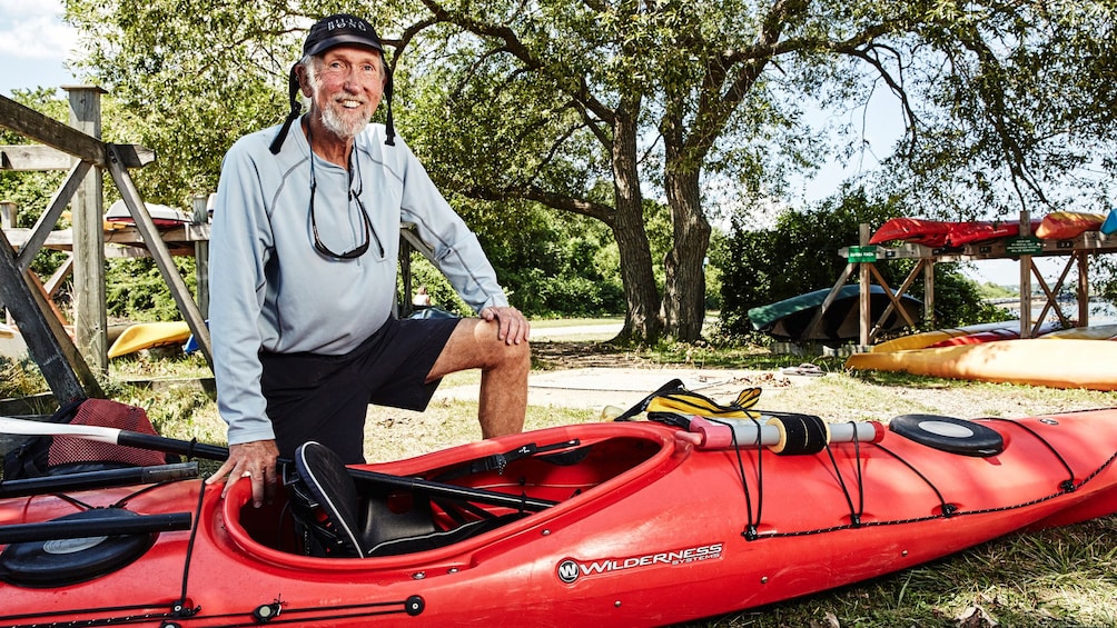 Older man with kayak in Casco Bay