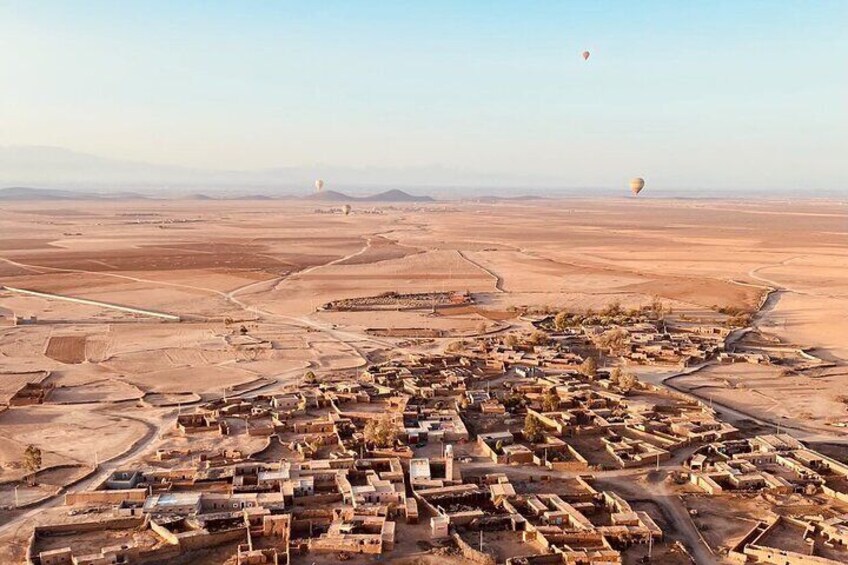 Hot air balloon flight in the desert with camel ride