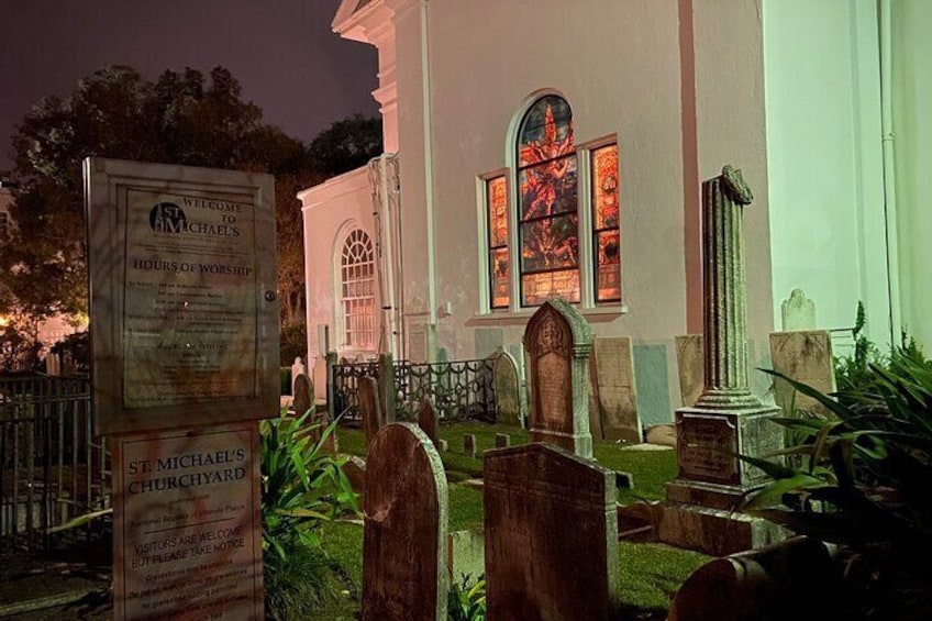 The churchyard at St. Michael’s with the illuminated stained glass at night!