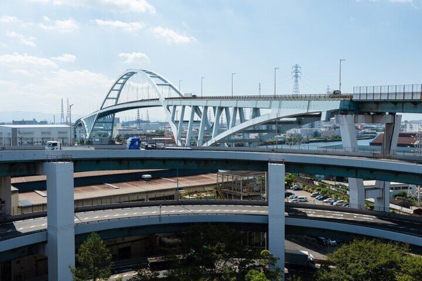 Riding a bicycle on a bridge over the canal.One of the longest arch bridge inJapan.