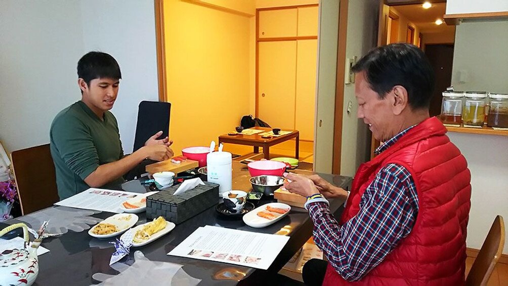 Two men crafting sushi in class in Osaka