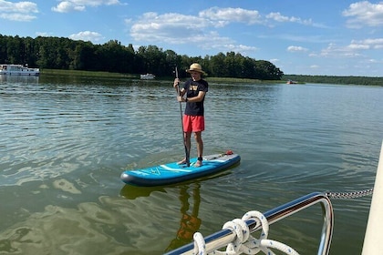Private guided stand-up paddling activity by motorboat