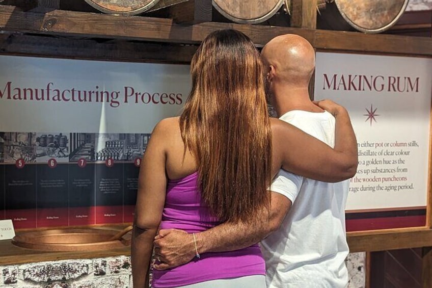 Couple in the Mount Gay Rum History Museum looking at the process of rum making 