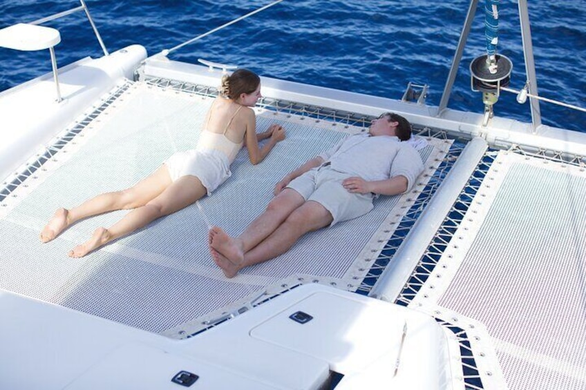 Lounging on the bow trampolines watching the water pass by below