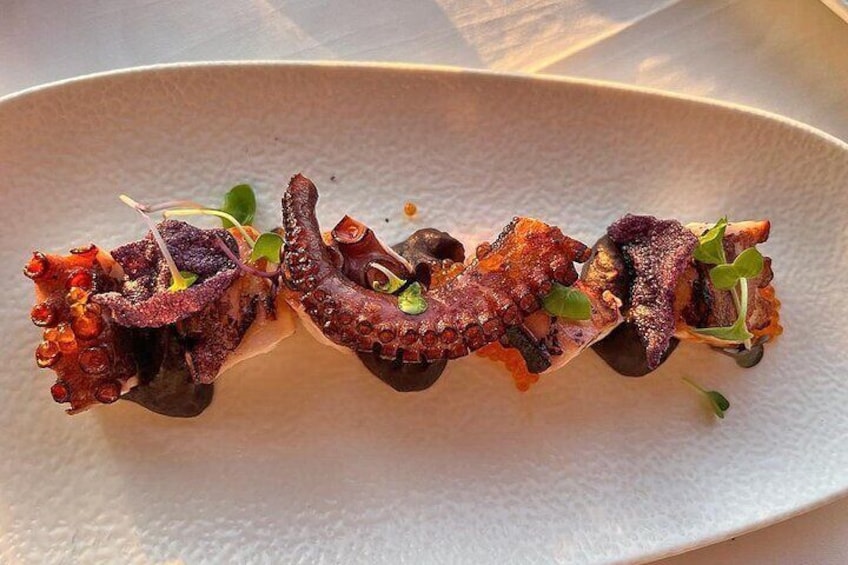 Octopus cooked at low temperature and finished on the grill with roasted red onion cream