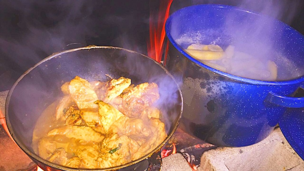 Food cooking in campsite pots