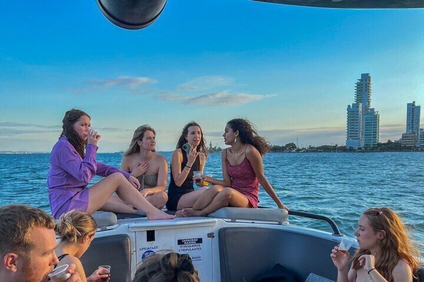 Open bar sunset party in the bay sharing with natives
