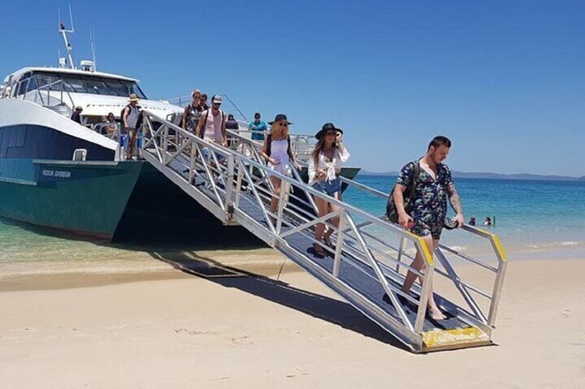 Seamless Arrival: Step ashore onto the pristine white sands of Great Keppel Island, where adventure begins and paradise unfolds.