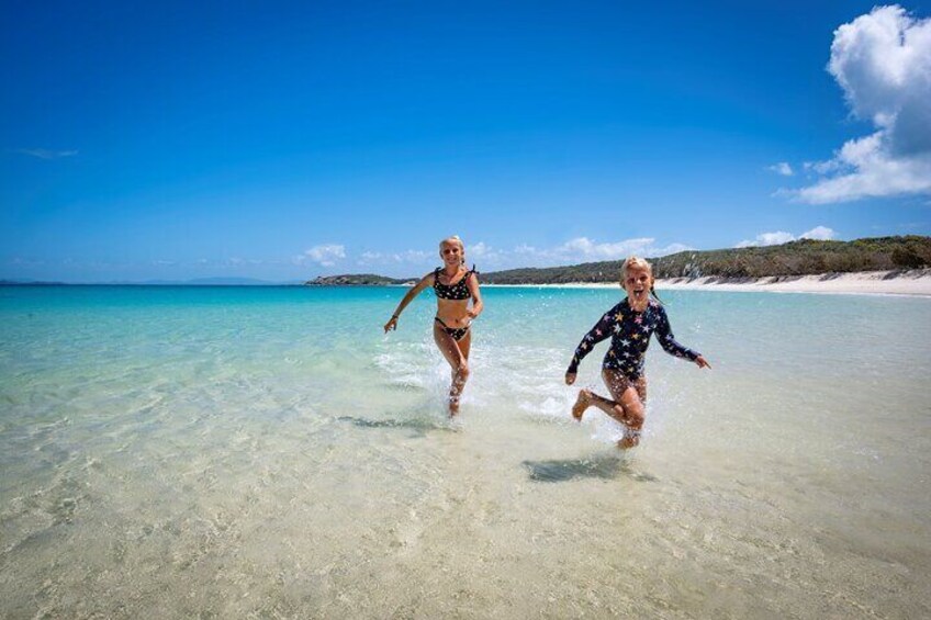 Joyful Escape: Embracing the endless beauty of Great Keppel Island on the picturesque Long Beach.