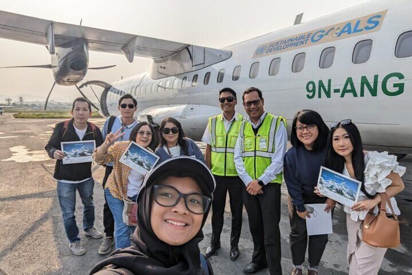 Travelers taking pictures after the thrilling mountain flight