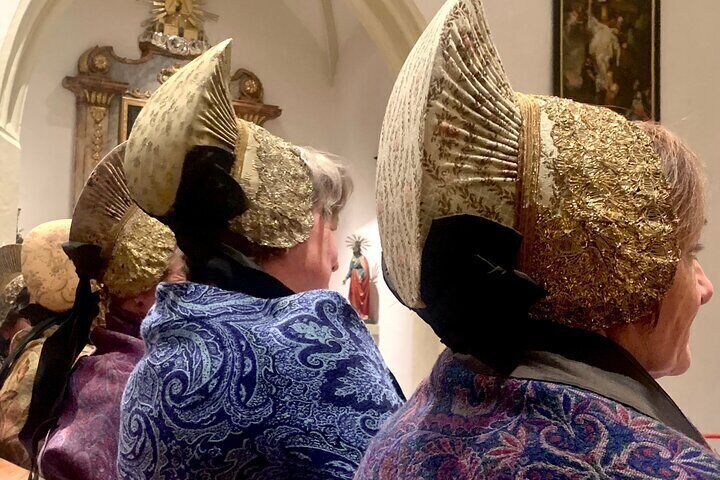 Women wearing gold caps during new wine blessing mass in Weißenkirchen in the Wachau valley