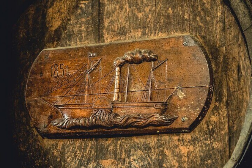 Bodega Mallorca unique tasting experience. Close up of a century year old barrel aligned in the cellar of the winery and distillery founded in 1851 in Mallorca. Discover a historic underground cellar.