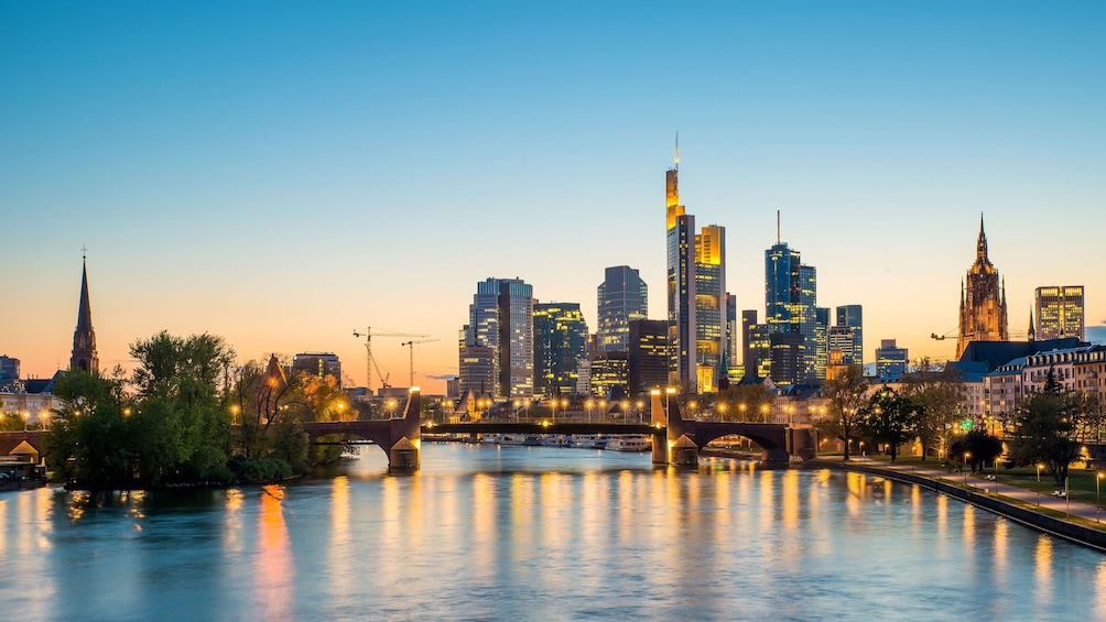 View of skyline from river at dusk in Frankfurt