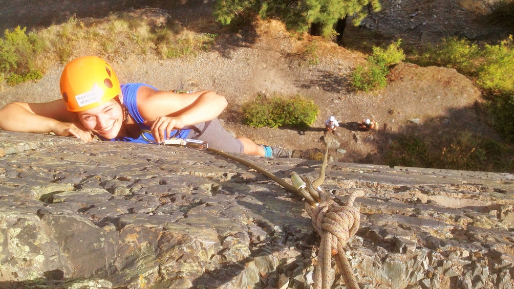 Show item 1 of 4. Downward angle of rock climber on a rock face