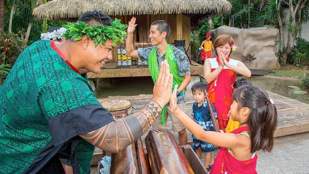 Show item 4 of 5. Family at the Polynesian Dinner Show in Guam