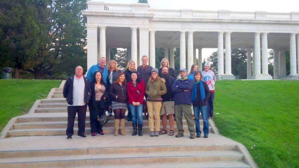 Ghost tour group on steps of Mansion during day