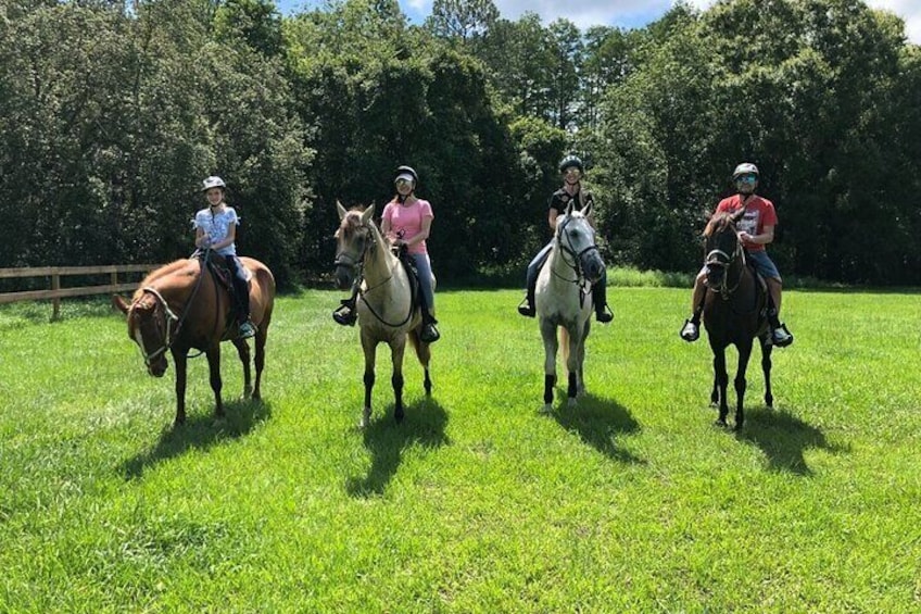 A happy group of riders returning from their trail. 