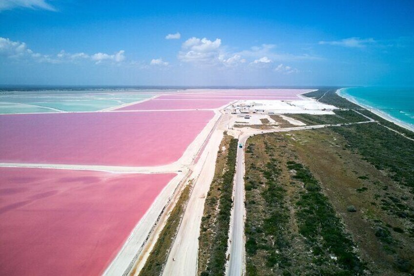 Aerial view of Las Coloradas' stunning pink salt flats — a must-see on our Las Coloradas & Rio Lagartos Tour. Marvel at nature’s vibrant hues and make unforgettable memories. 